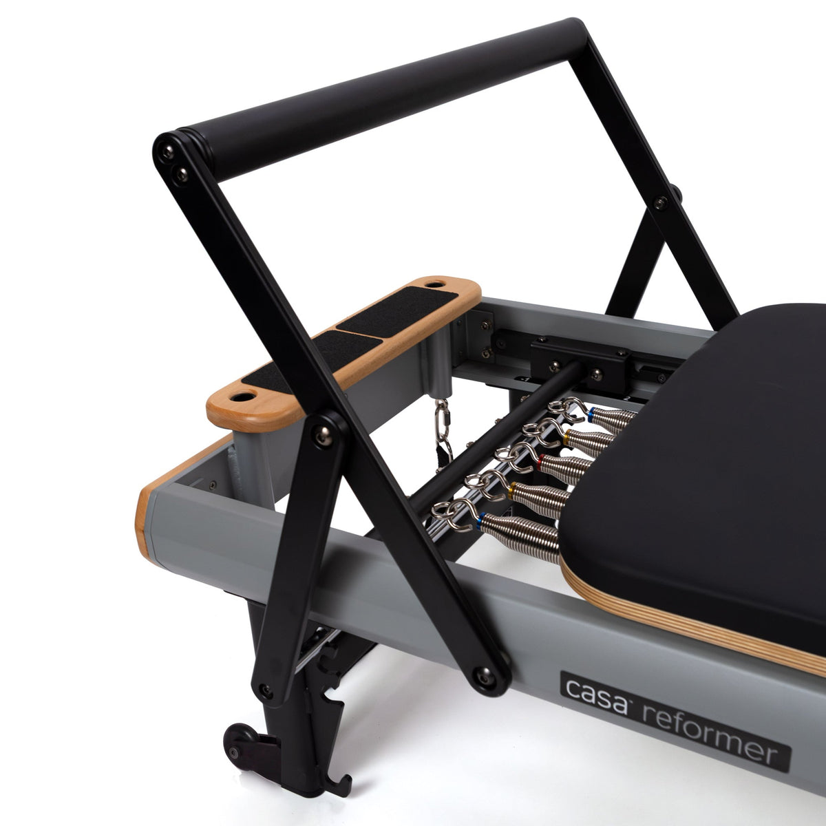 High-angle detail of folded long/short box, color-coded springs, and black metal frame structure at headrest end