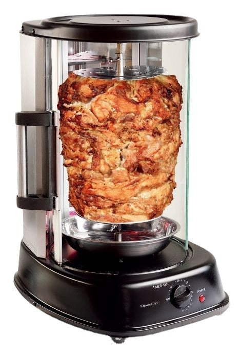 Close-up of seasoned layered meat rotating on vertical spit inside electric grill, highlighting browning texture above