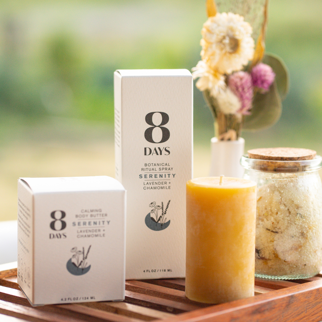Serenity Botanical Bath Ritual Kit on wooden tray with white body butter, amber spray, yellow candle, and corked bath salts