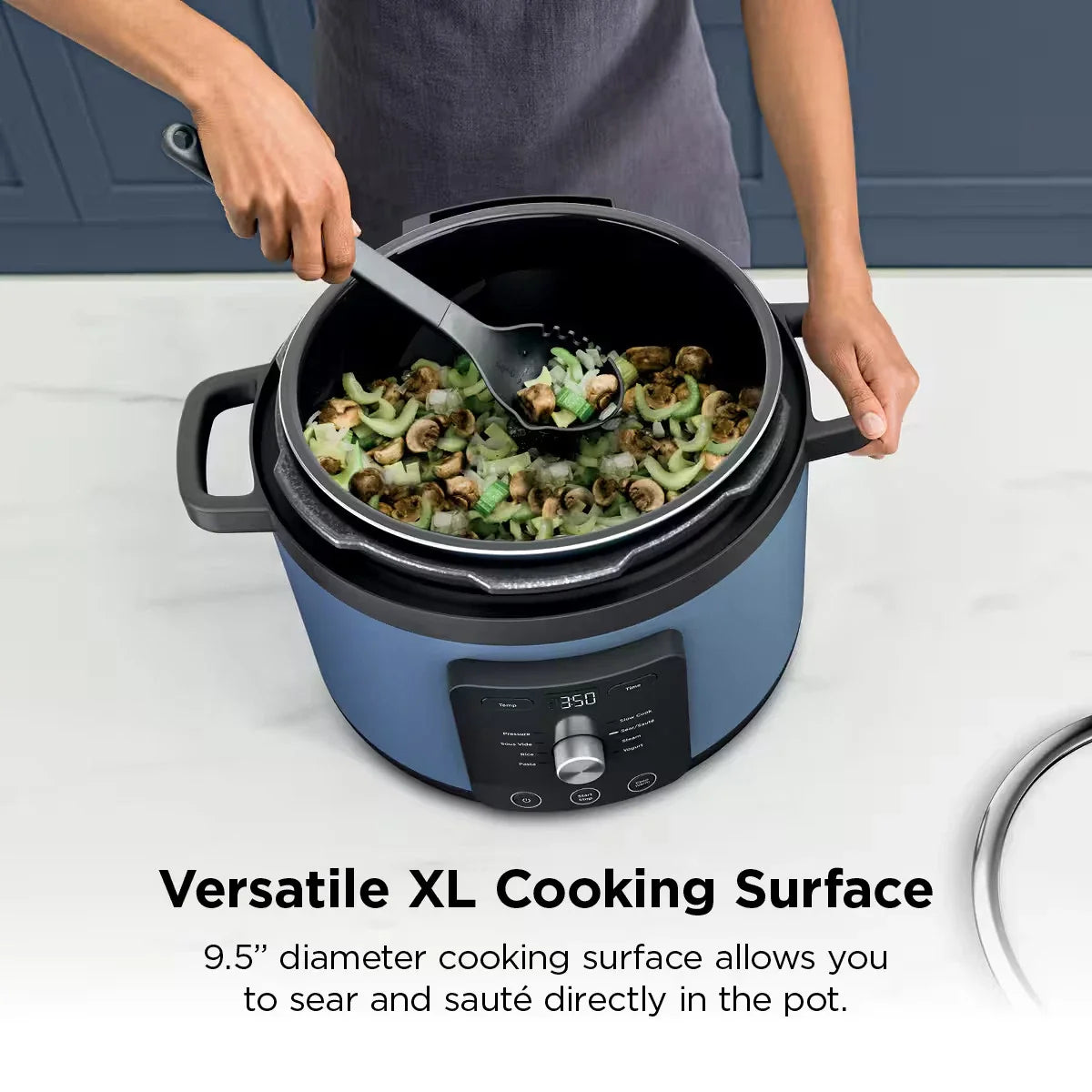 Overhead view of sautéed vegetables in the open stainless steel inner pot of a Ninja electric pressure cooker