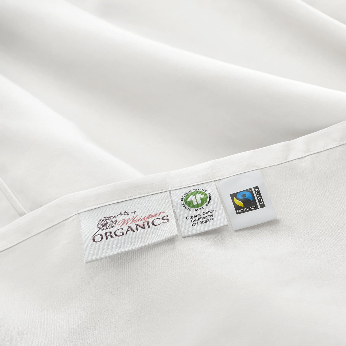Product tags showing GOTS and Fairtrade logos sewn into hem