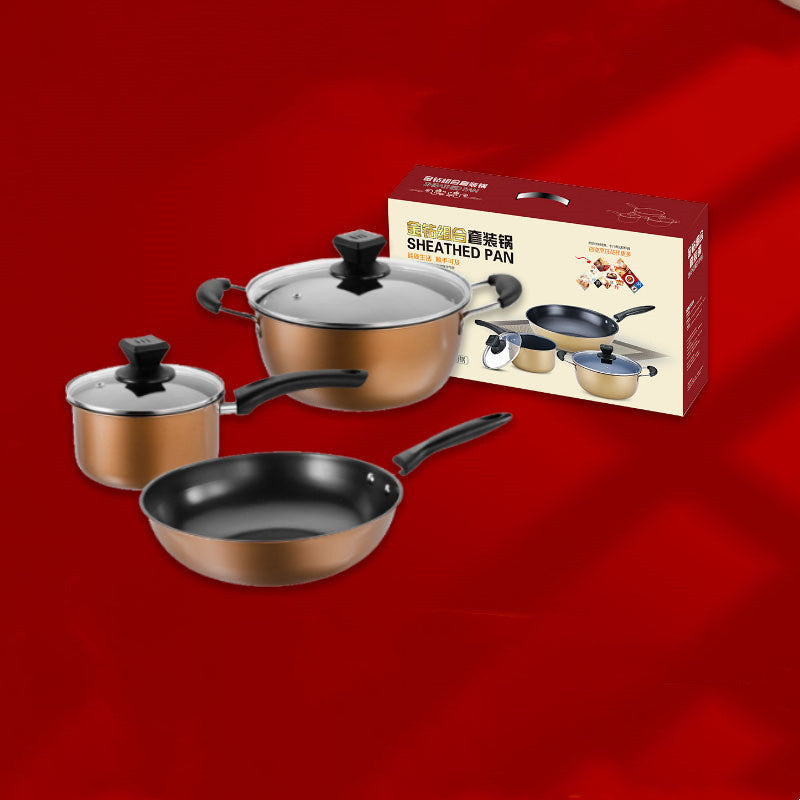 Three-piece gold cookware set arranged in front of retail packaging box against red background