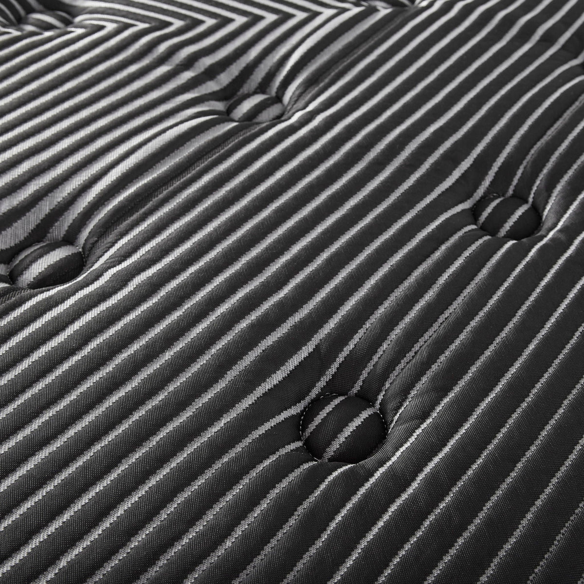 Close-up of black and white striped Eurotop fabric with deep tufted button detailing