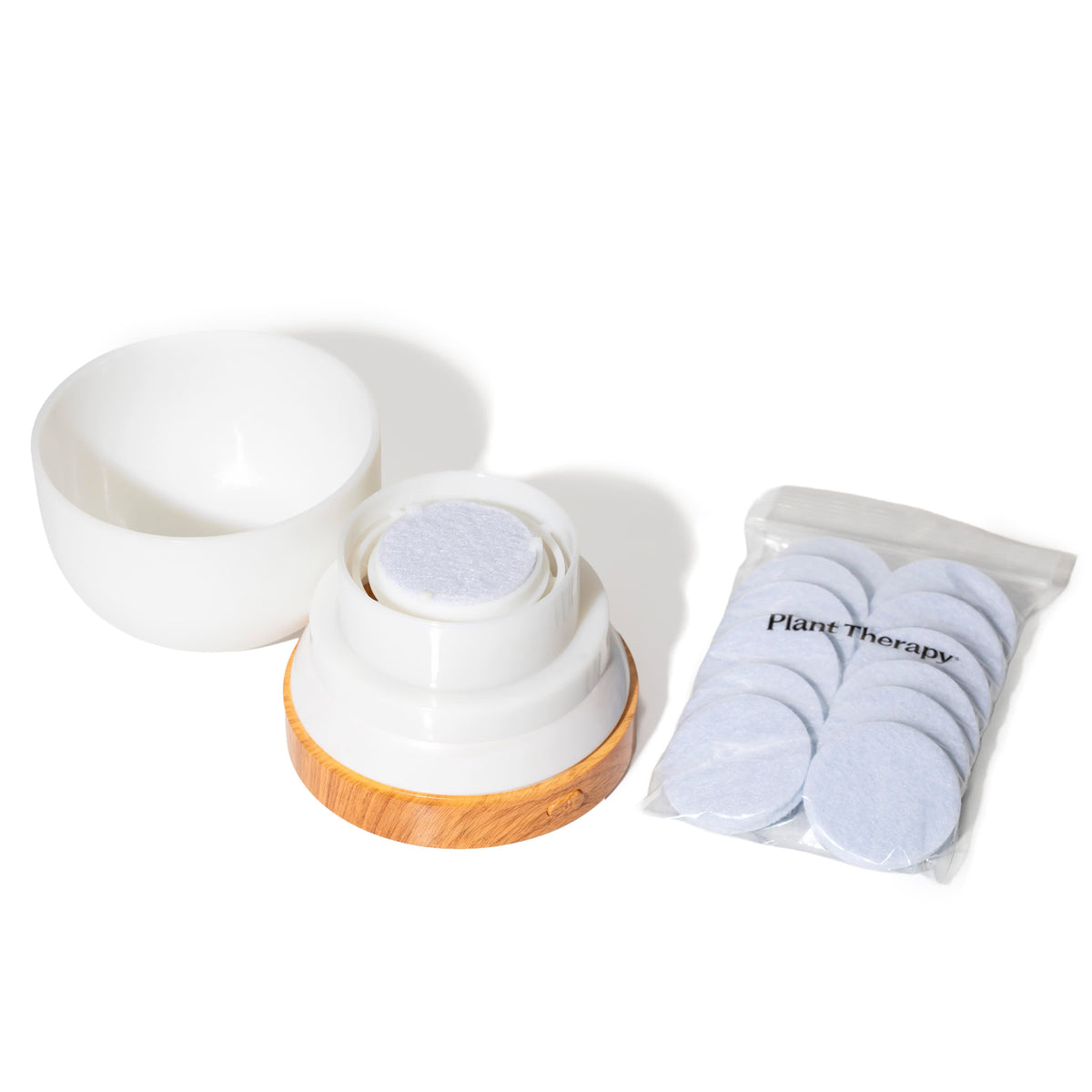 Exploded view of white dome cover revealing internal fan mechanism and fiber pad holder beside replacement pads