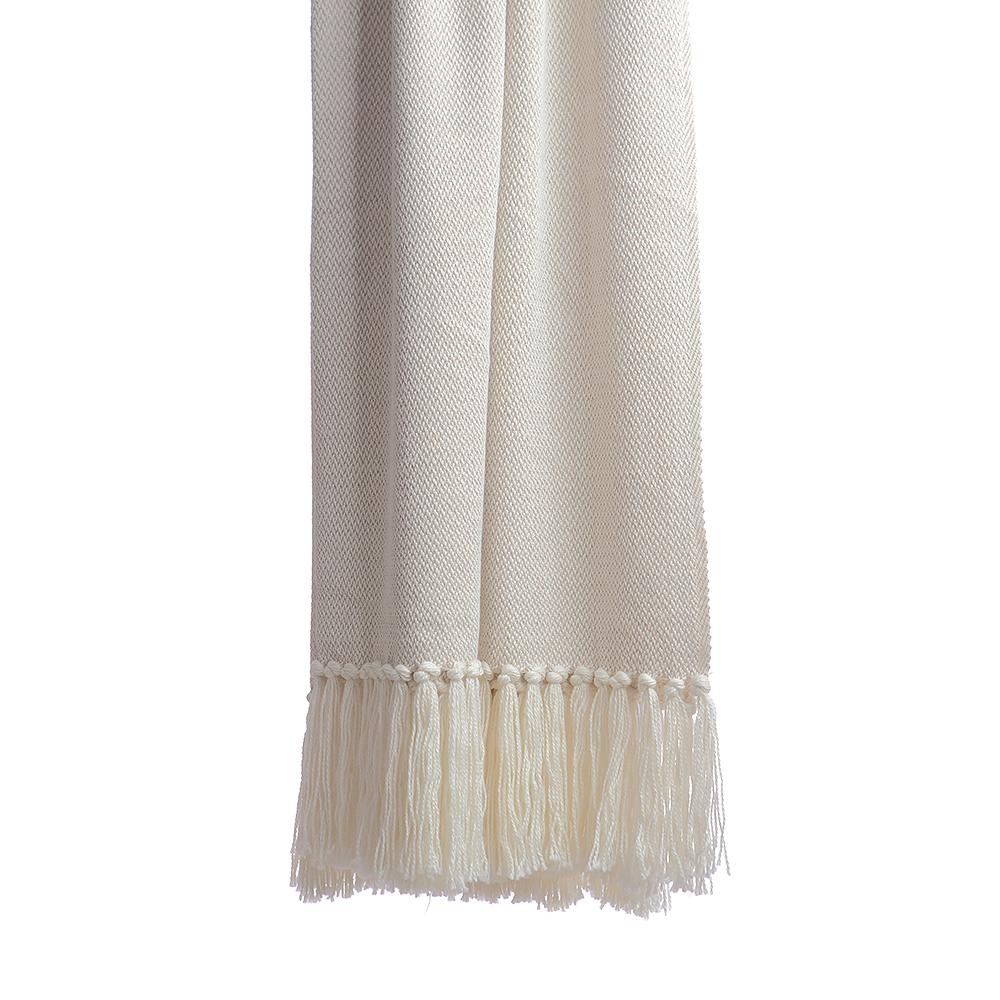 Vertical detail of ivory melange throw highlighting consistent diamond-patterned weave and intricate hand-knotted fringe trim
