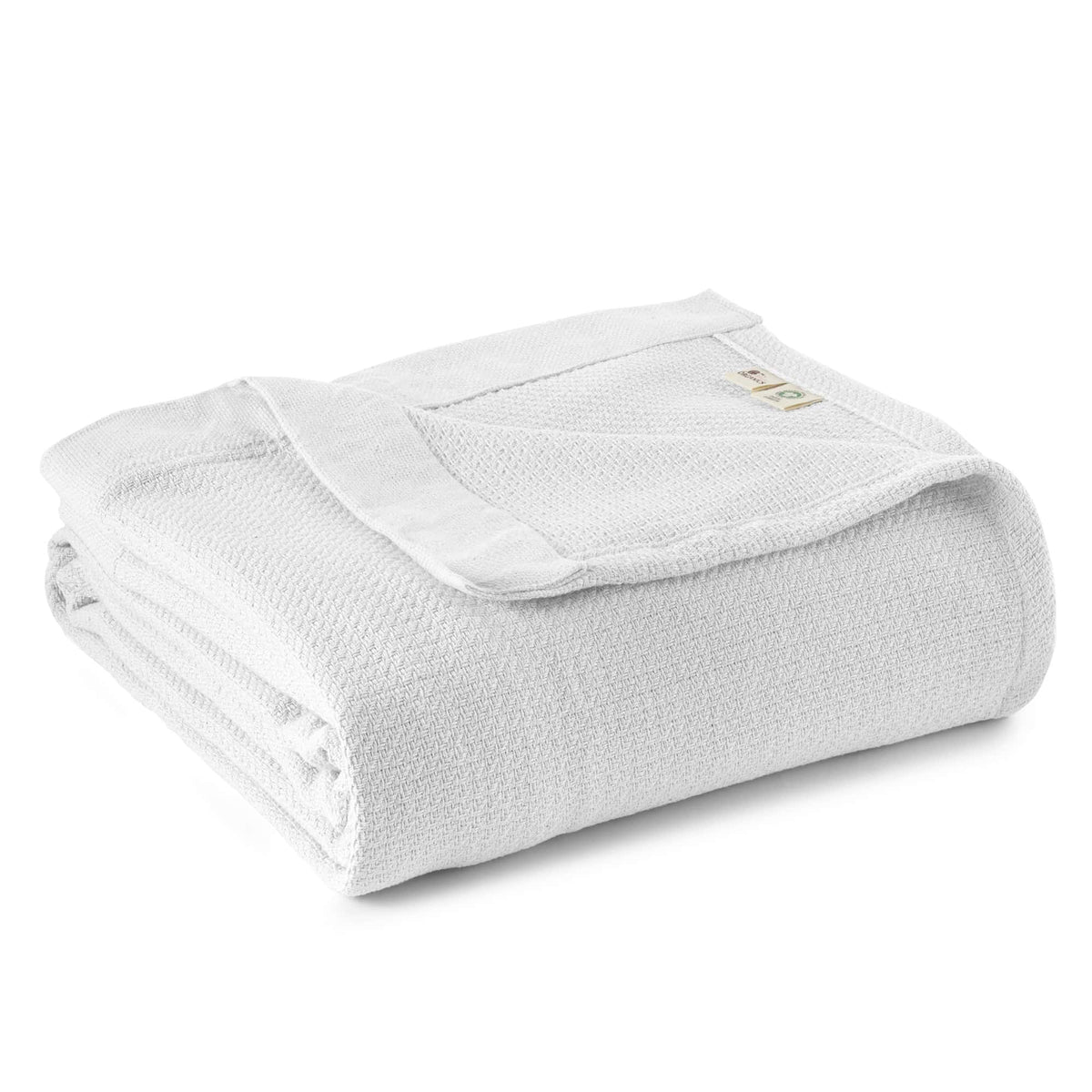 Light heather grey organic woven blanket folded to show breathable texture and label on white backdrop