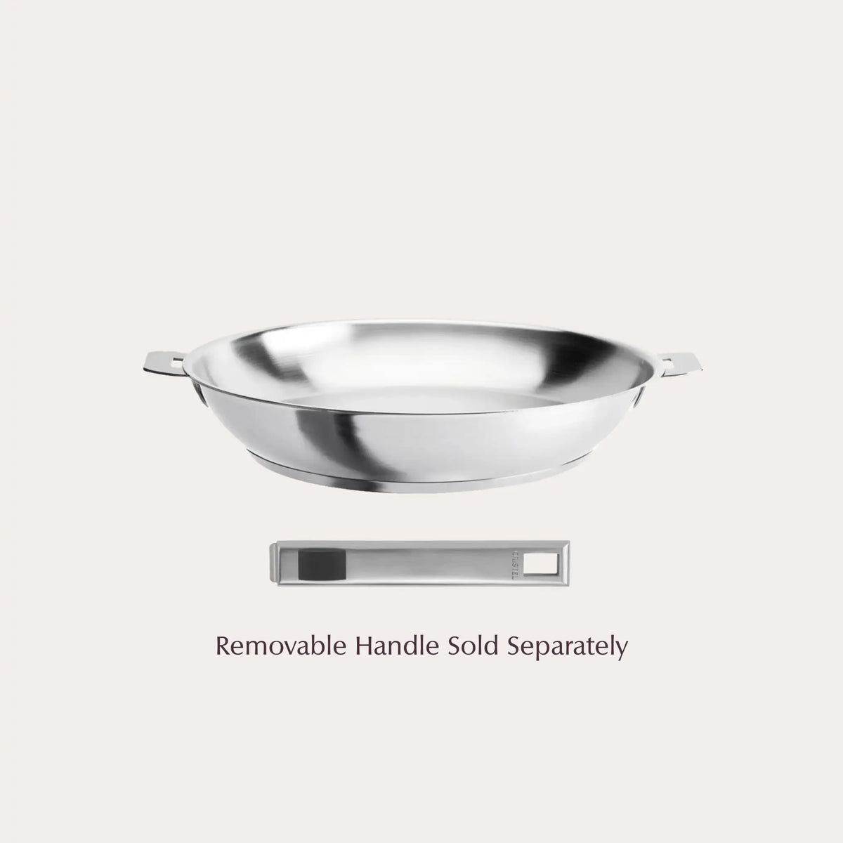 Brushed stainless steel Strate pan with small side handles next to separate black grip detachable handle