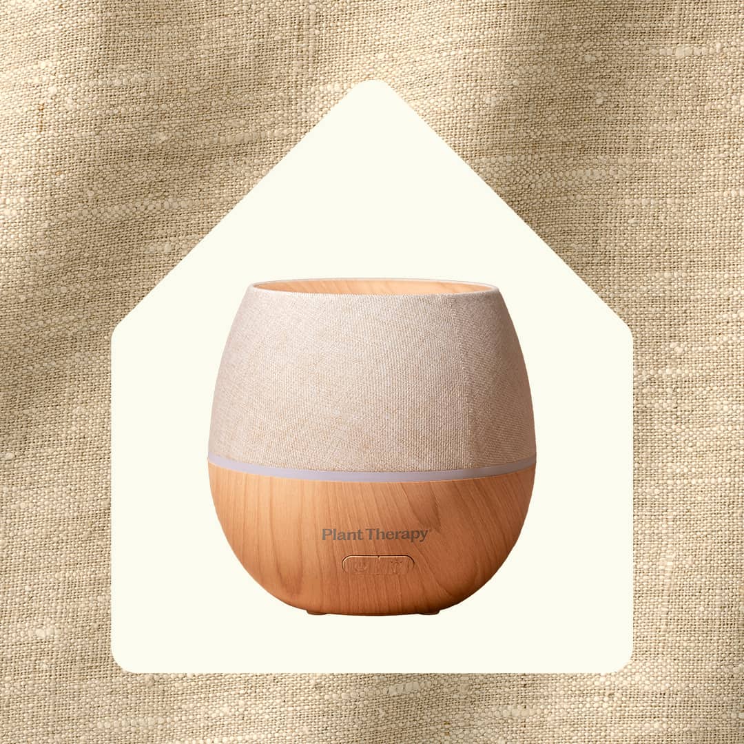 Diffuser inside house silhouette on burlap background emphasizing home decor style