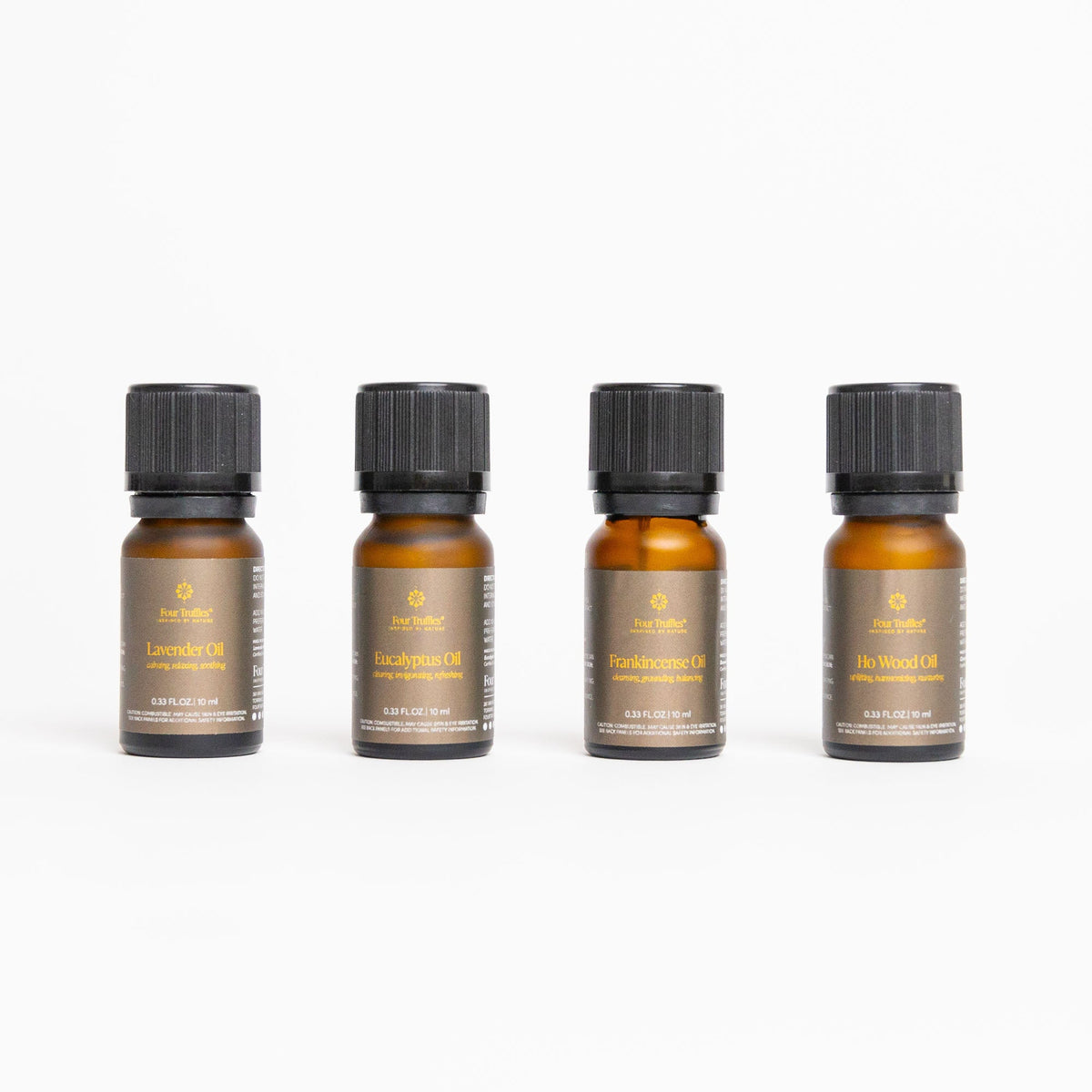 Front-facing lineup of four labeled essential oil bottles on white background showing Lavender, Eucalyptus, Frankincense, and