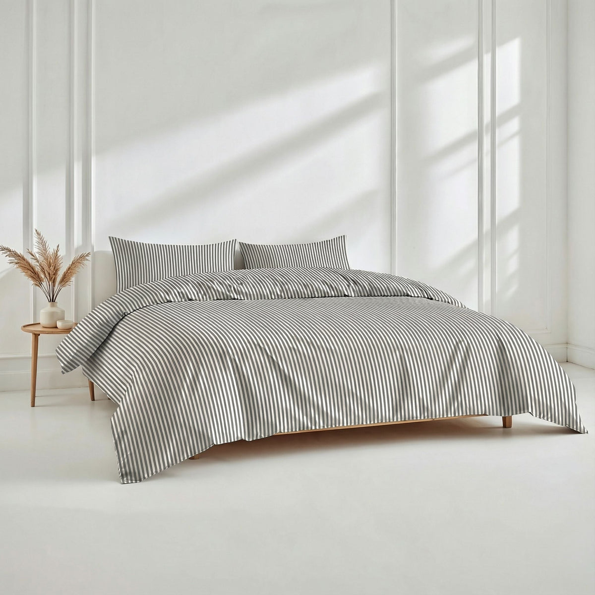 Dense dark grey vertical stripes on white sateen fabric highlighted under soft natural lighting