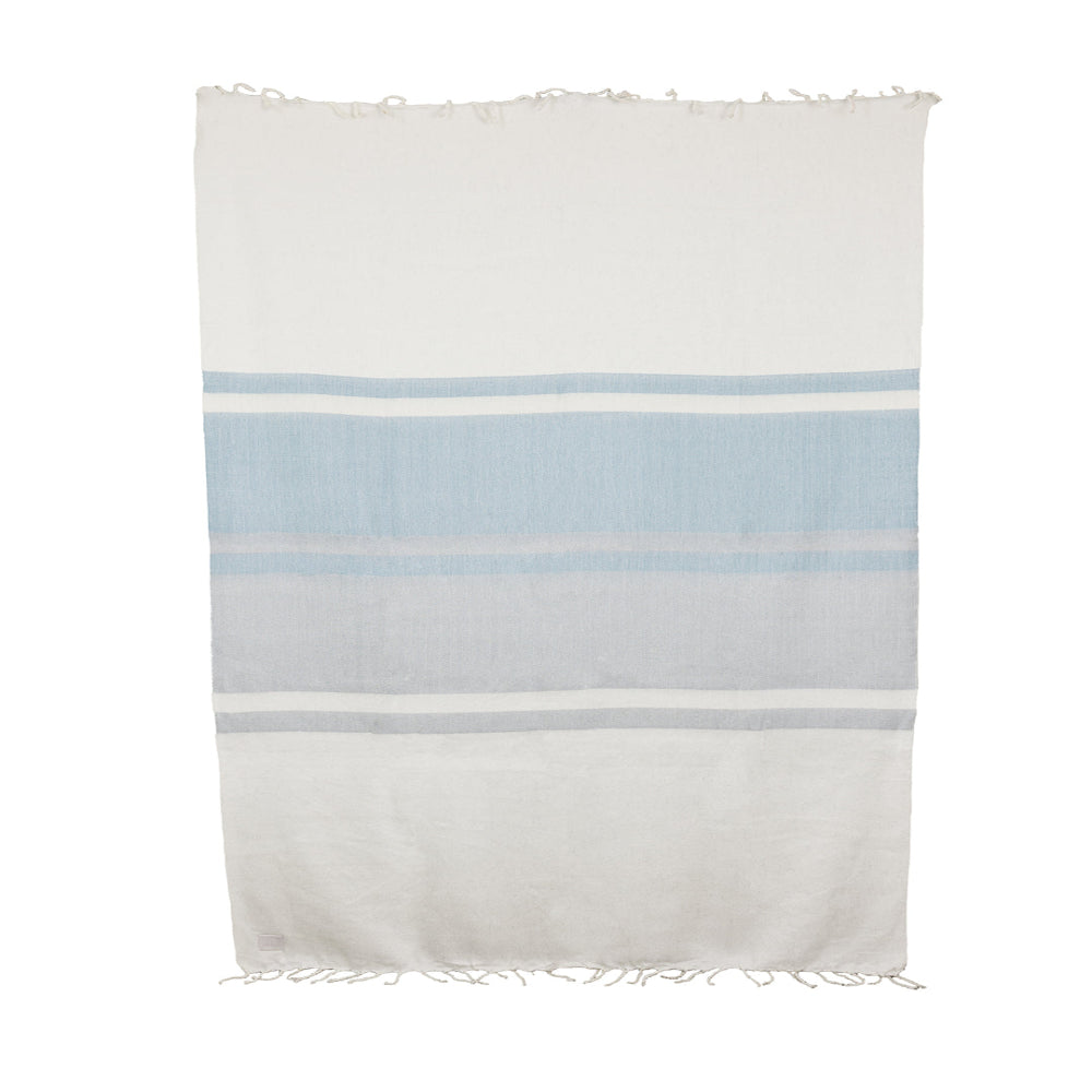 Flat-lay of Glacier Gray and white handwoven alpaca blanket with twisted fringe
