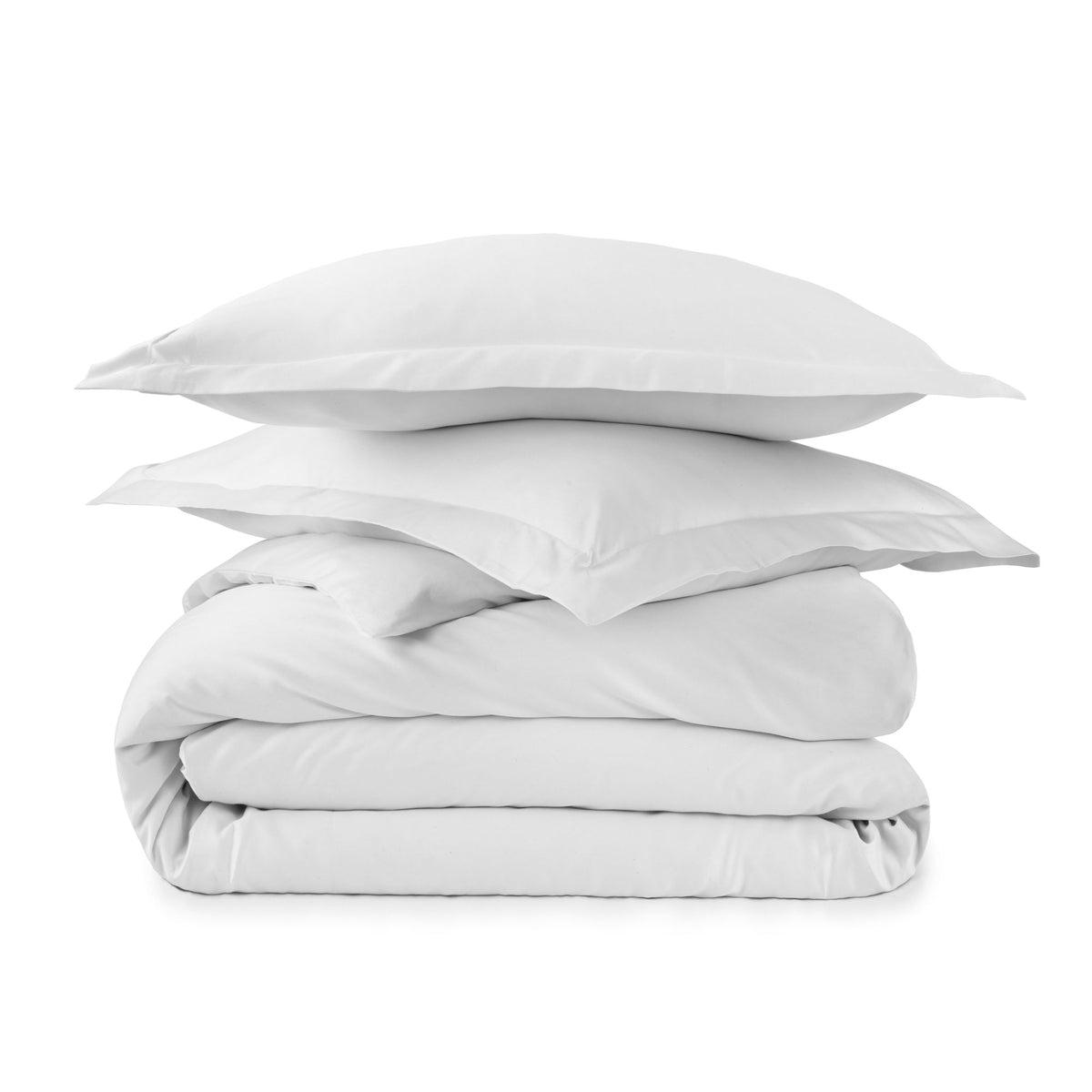 Pristine white folded duvet cover set with stacked shams emphasizing minimalist design
