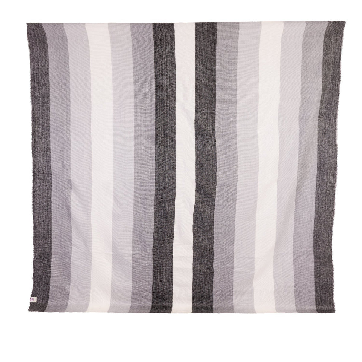 Rectangular handwoven alpaca blanket with black to white stripes and visible tag on white background