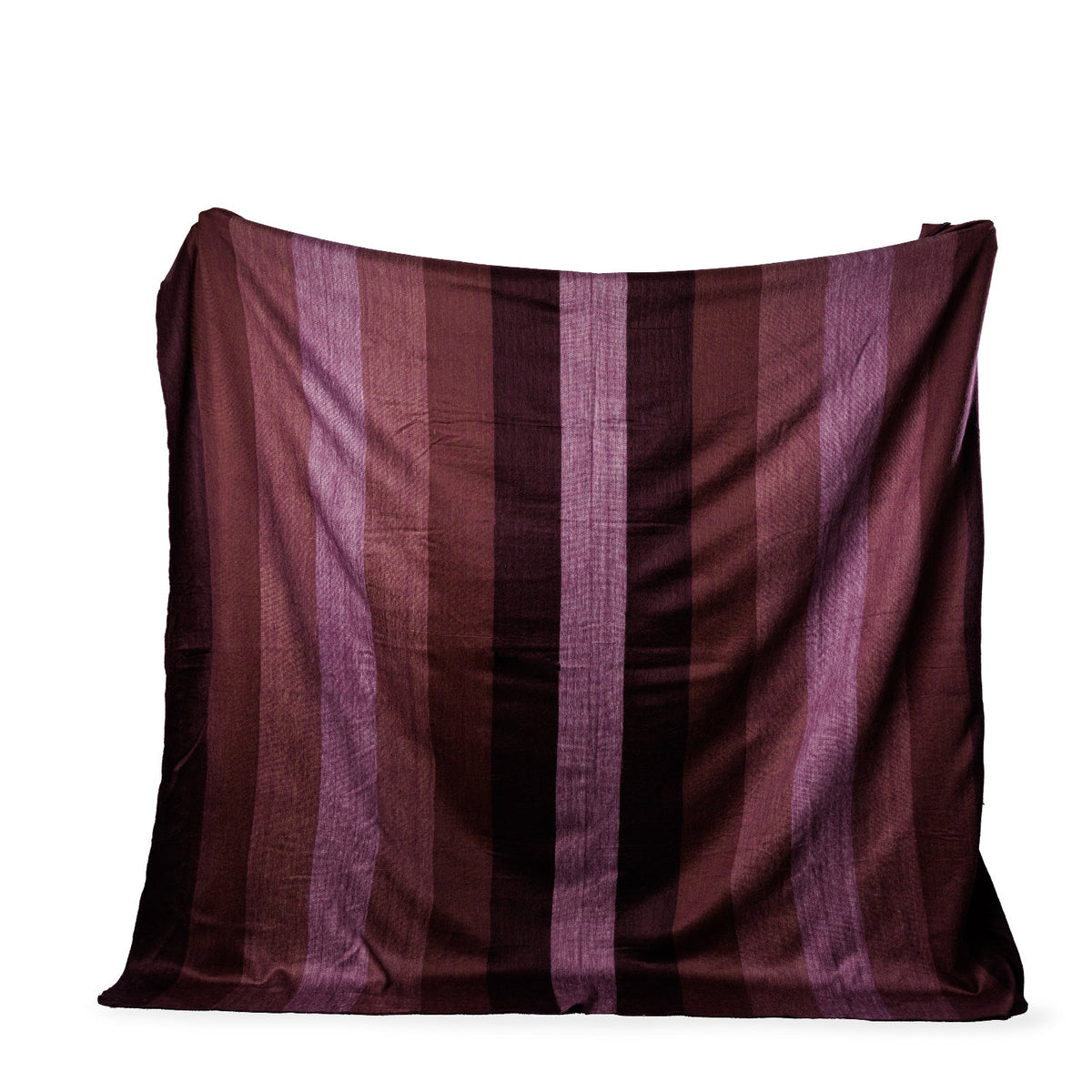 Flat lay of square alpaca throw with vertical stripes in deep purple and burgundy