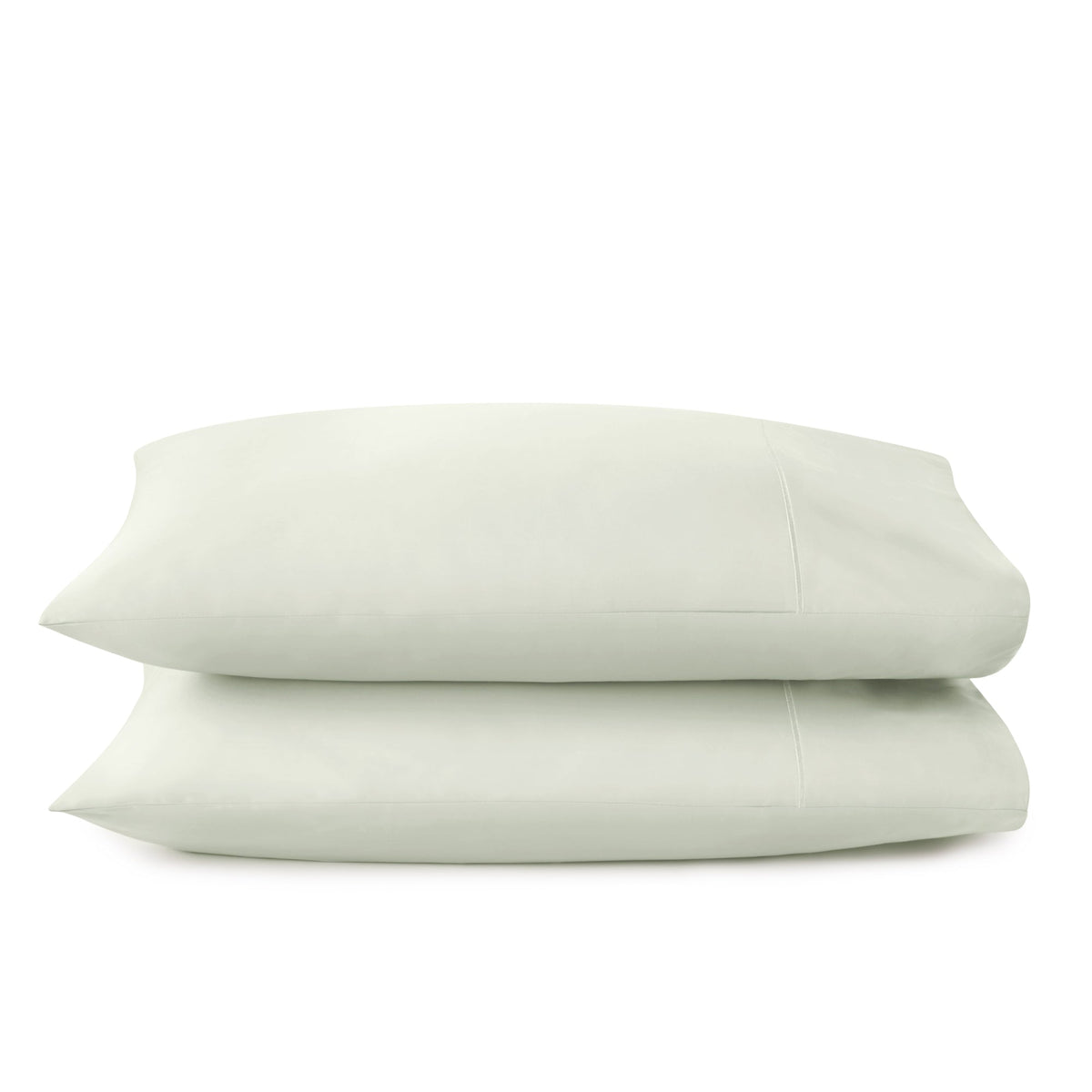 Pale sage green organic cotton sateen pillowcases with gentle luster and precise seam detailing
