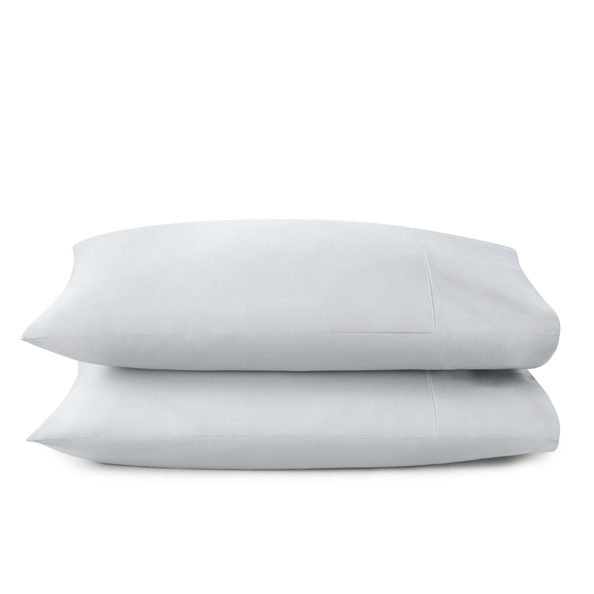 Stack of two light grey organic cotton sateen pillowcases with envelope closure on white background
