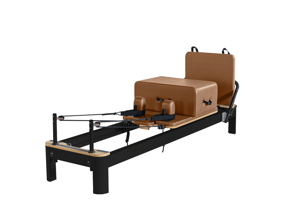 Matte black frame reformer with light wood end caps and cognac brown padded upholstery on white background