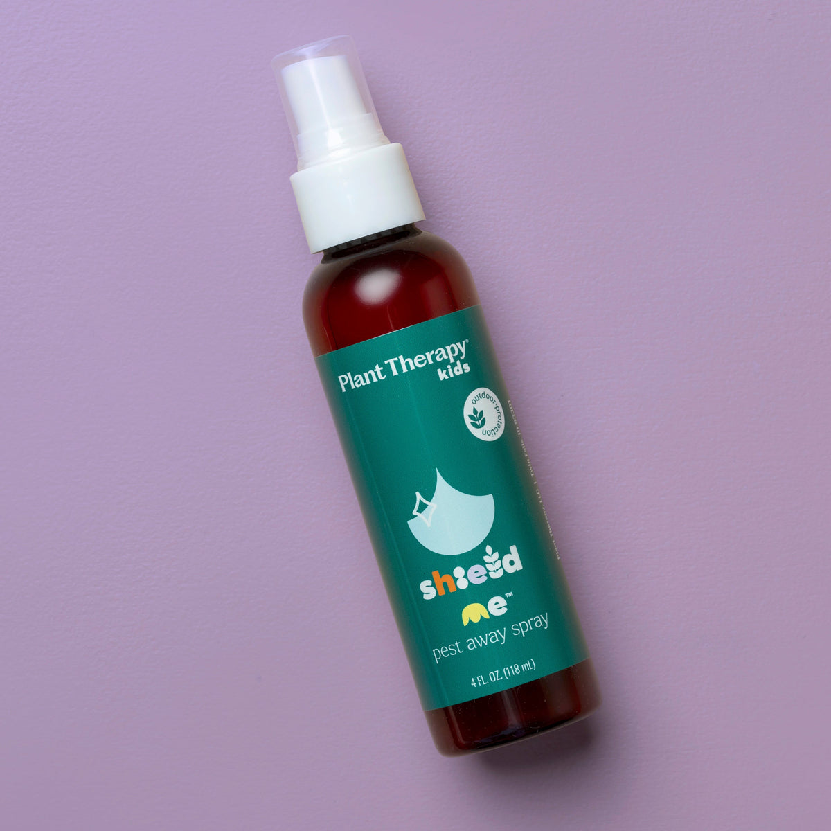 Amber spray bottle angled diagonally on solid lavender purple background highlighting teal label