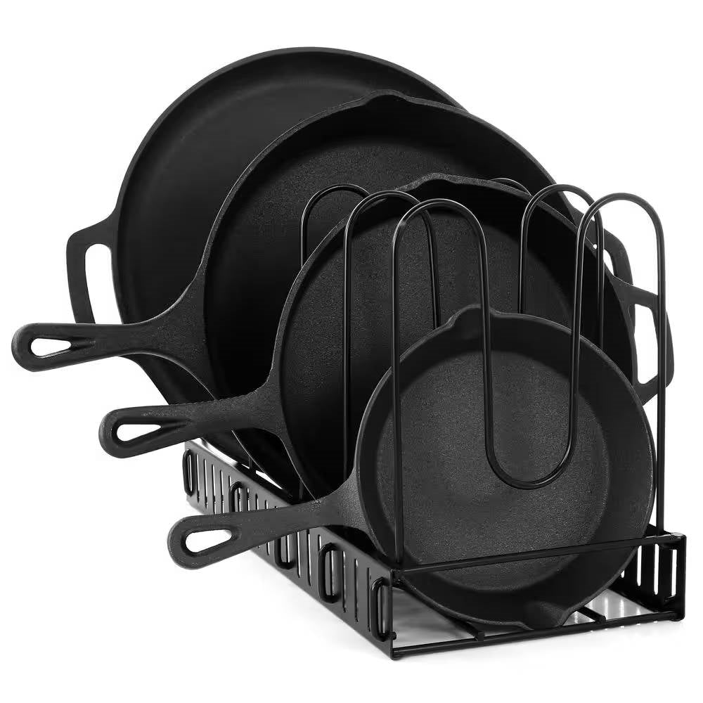 Four black cast iron frying pans stacked vertically in a black wire storage organizer rack
