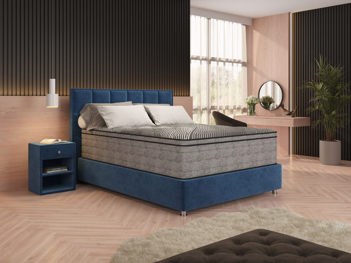 Pure Ice mattress on blue upholstered frame in modern bedroom with wood paneling and herringbone floor