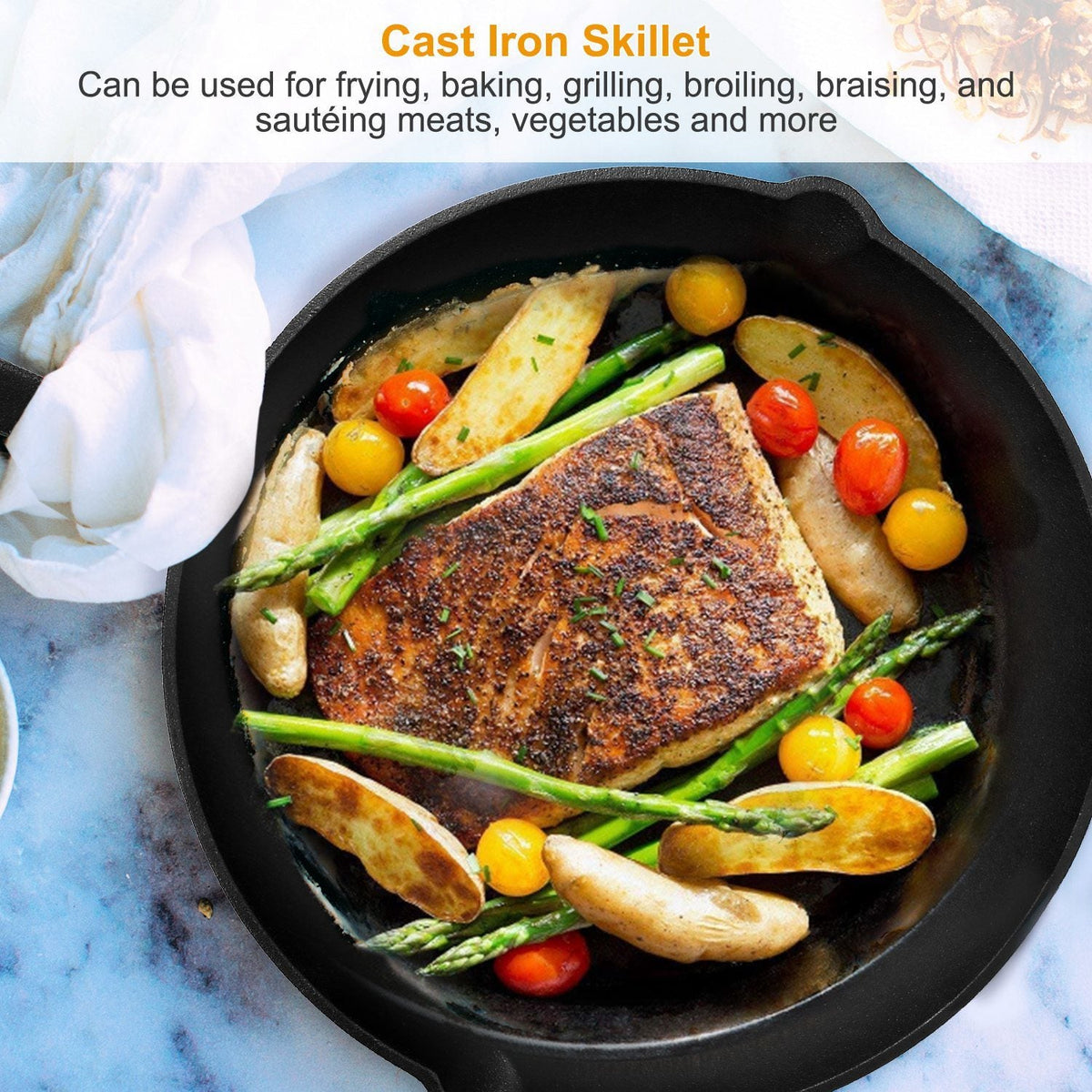 Seasoned cast iron skillet holding cooked salmon, asparagus, potatoes, and tomatoes on blue marble surface