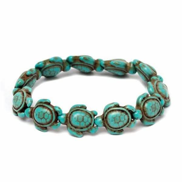 Handmade turquoise sea turtle bracelet with oval spacers and antiqued bronze beads on white