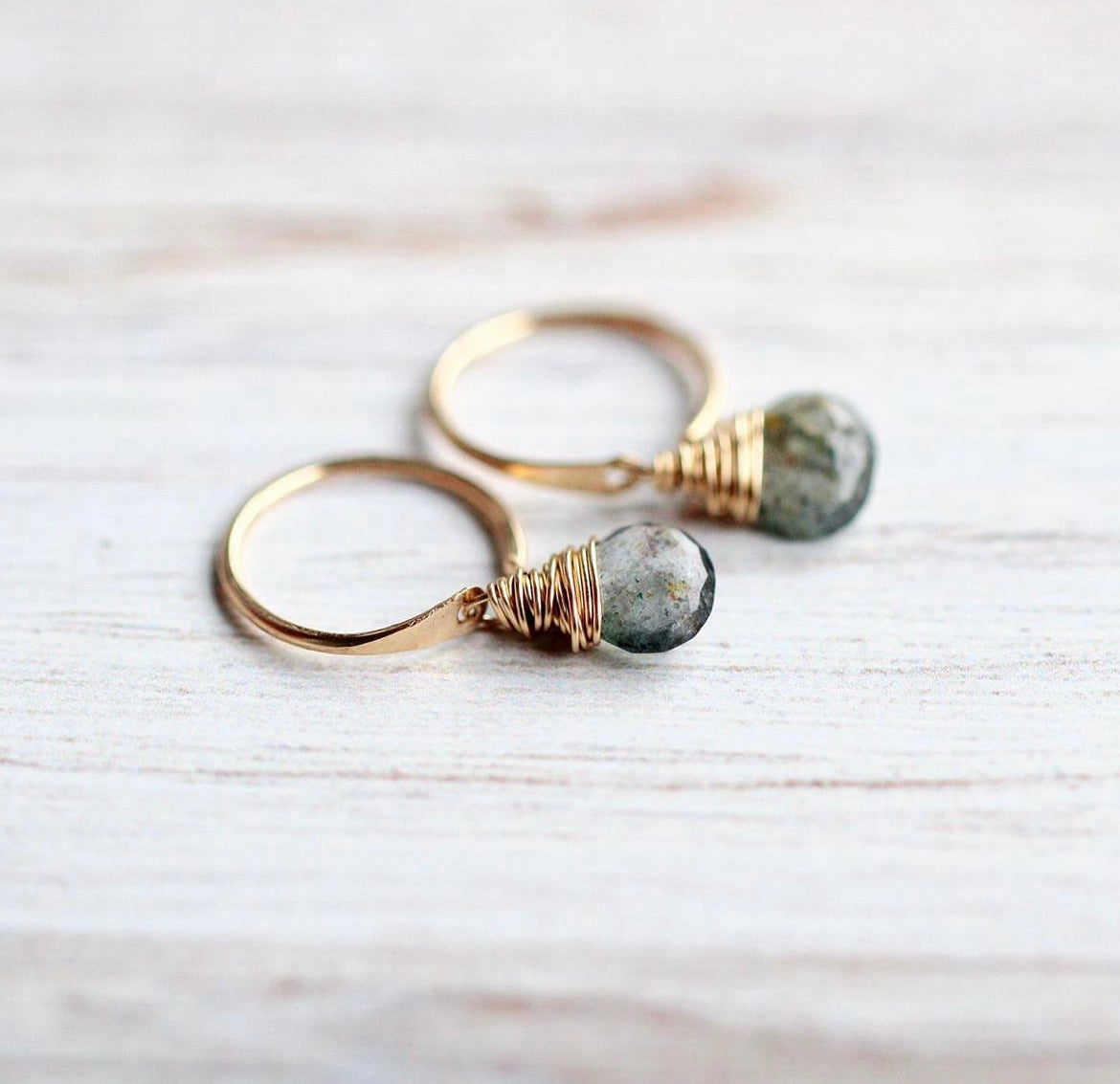 Gold-filled huggie hoops with faceted moss aquamarine briolettes on distressed wood