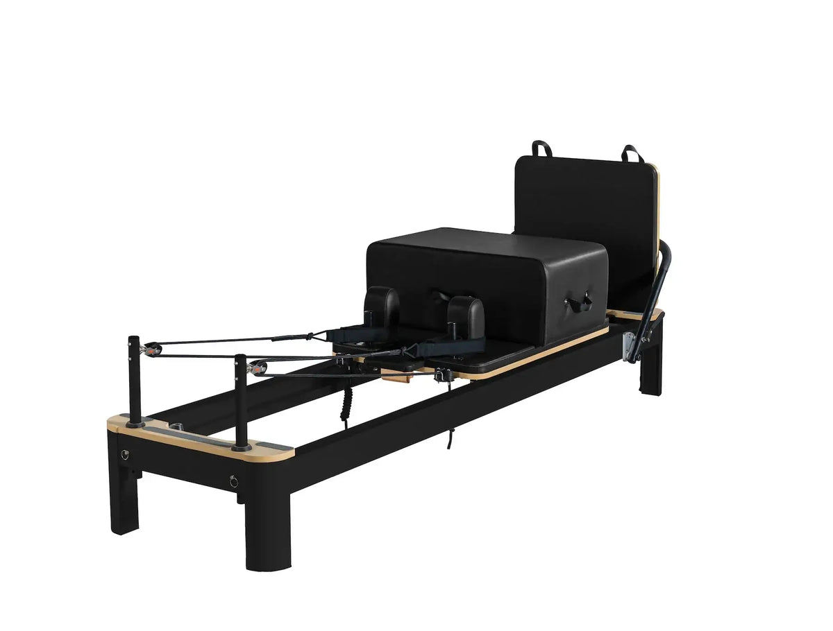 Matte black Queen Pilates Reformer with light wood accents and springs