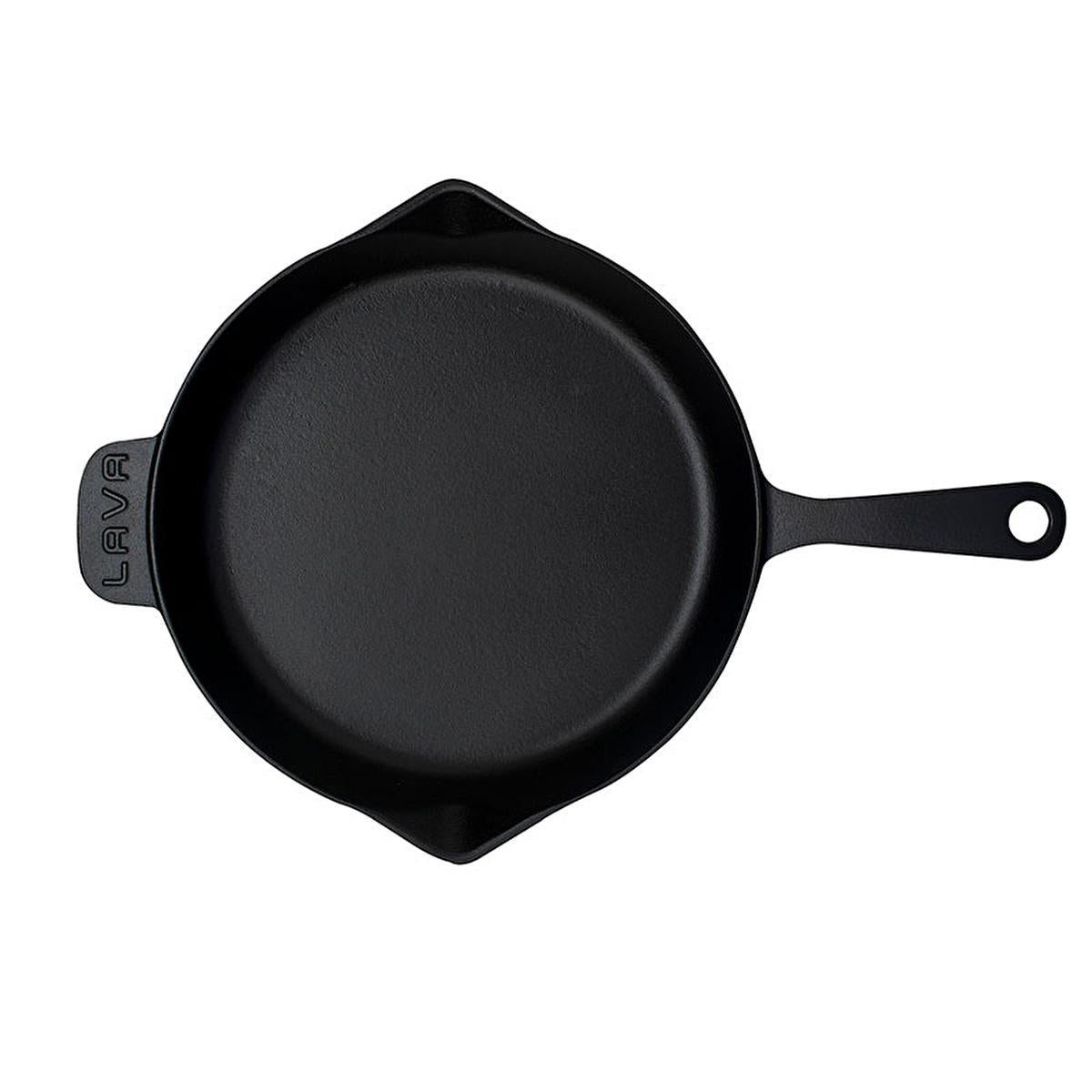 Top-down view of black enamel coated cast iron frying pan interior and spouts
