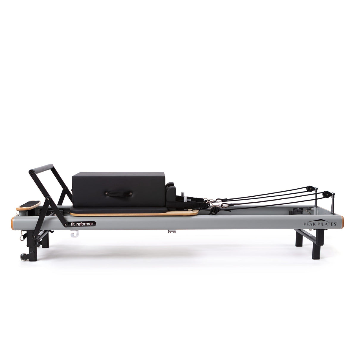 Straight-on view of grey fit Reformer with light wood trim, black long box on carriage, and tensioned black ropes extending