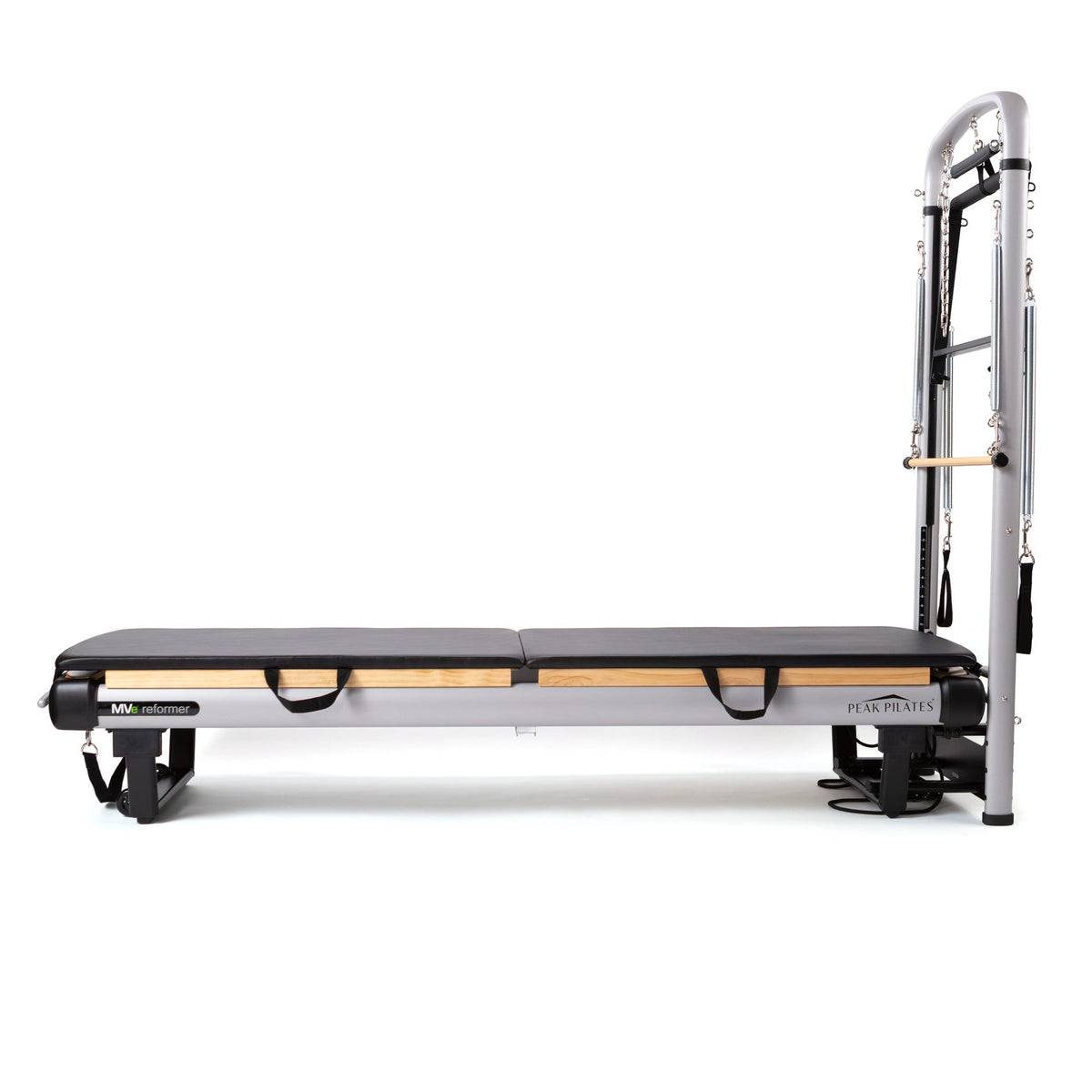 Side profile of flat mat configuration showing extended black pad, light wood base, and upright silver tower