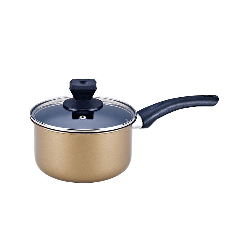 Gold saucepan with black handle and clear glass lid isolated on white background