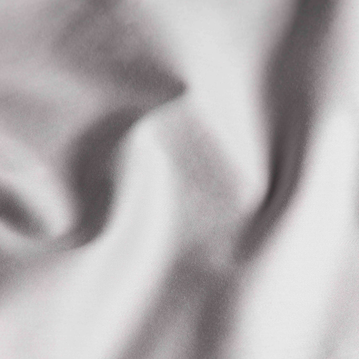 Macro shot of grey sateen fabric highlighting fine weave and subtle sheen