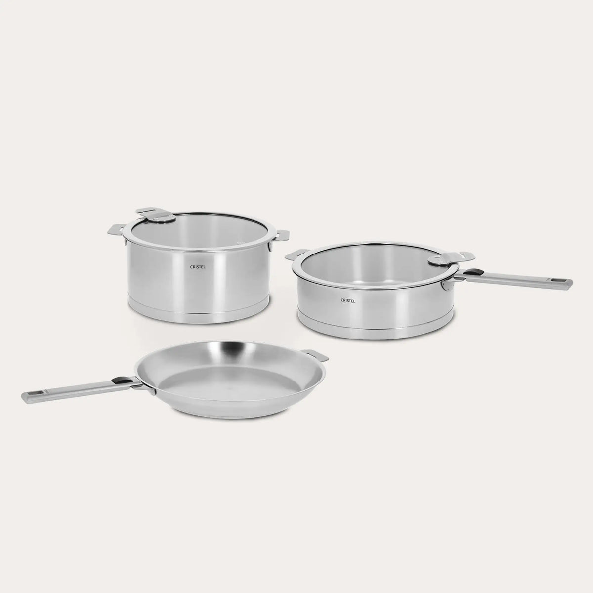 Three brushed stainless steel CRISTEL Strate pots with black logos on off-white background