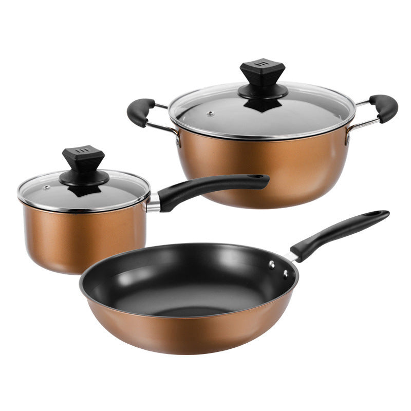 Complete three-piece gold cast iron wok, pot, and saucepan set with black handles on white