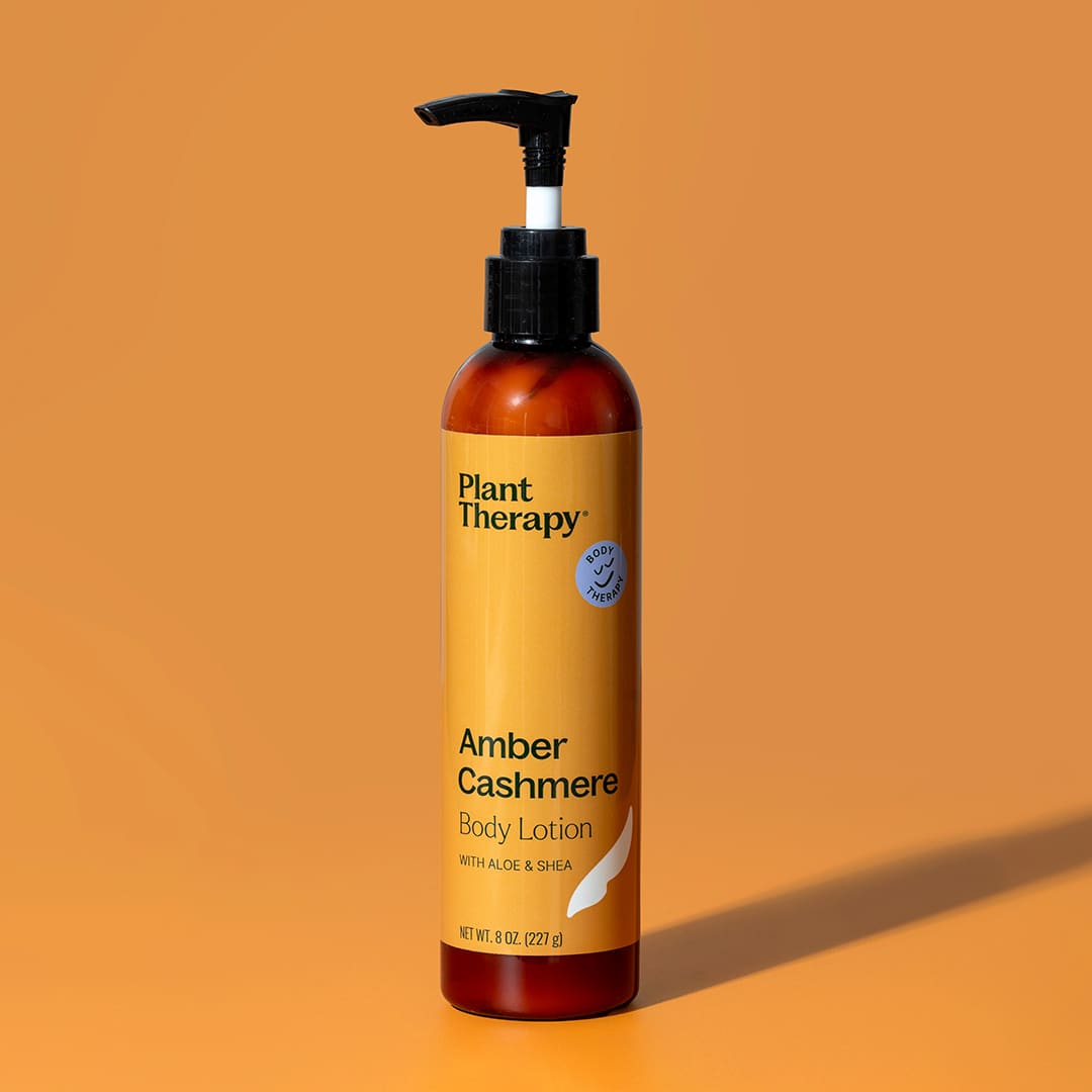 Front view of amber lotion bottle with yellow label on orange background