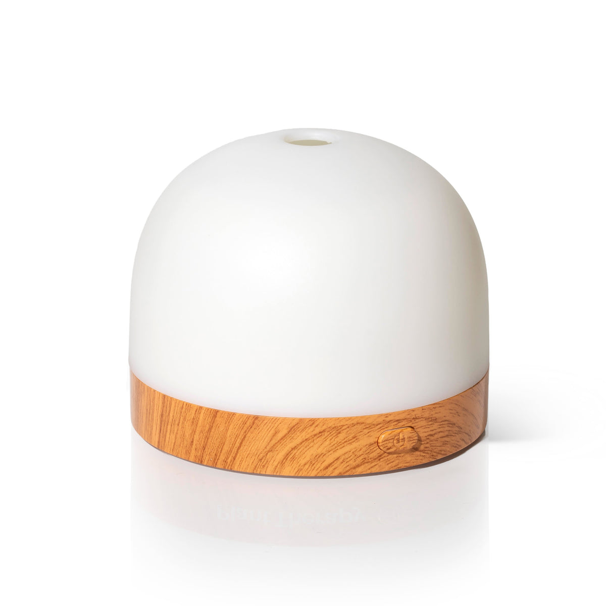 White dome-shaped AuraDrop diffuser with light wood-grain base and embossed power button against white background