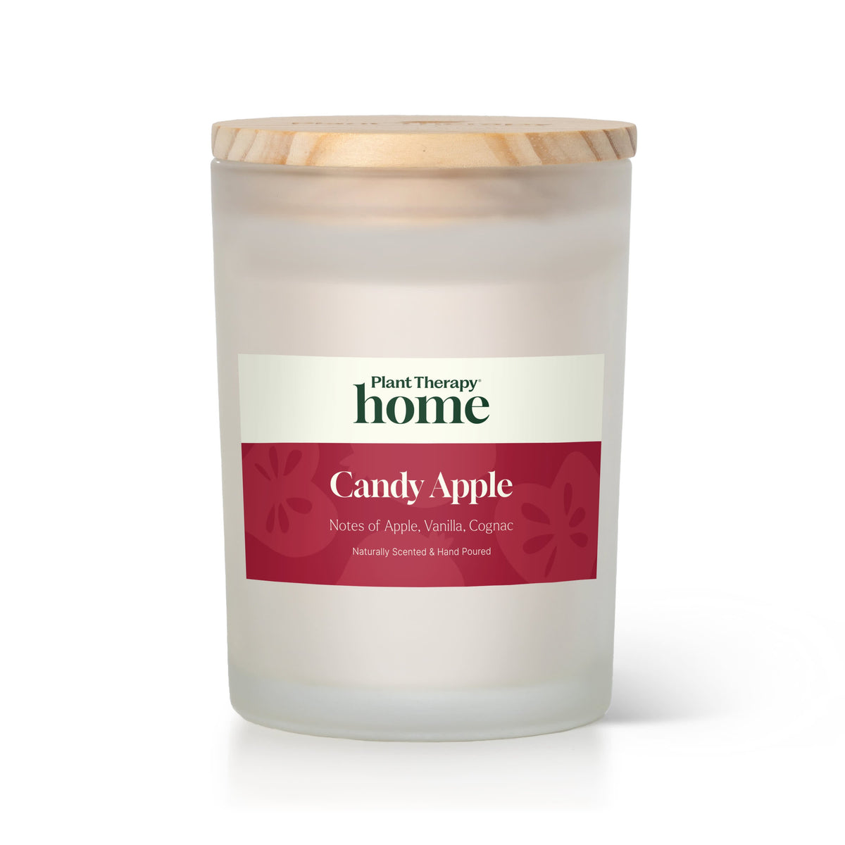 Frosted white glass jar candle with wood lid and red label listing apple vanilla cognac notes