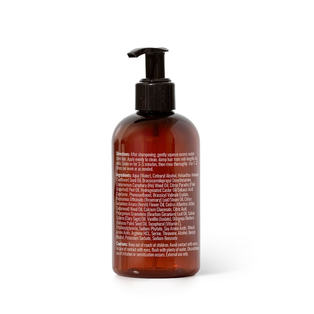 Back of amber bottle showing detailed ingredient list and safety warnings in white text
