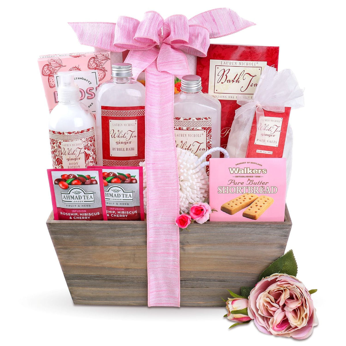 Spa gift basket arrangement with white bath puff, bottles, and fresh pink roses attached to the rustic wooden crate