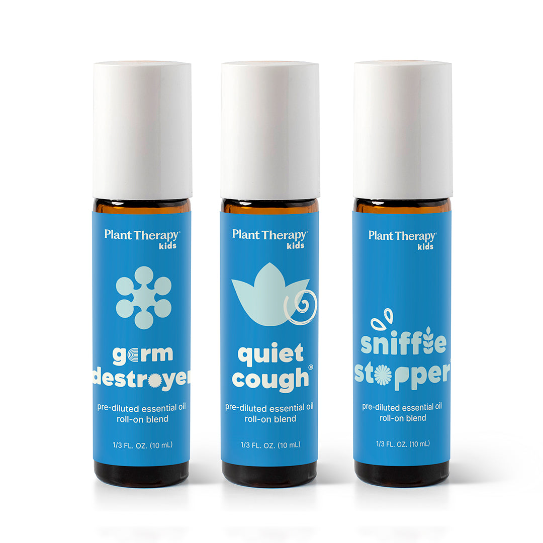 Three amber glass roll-on bottles with white caps and blue labels standing upright on a white background.