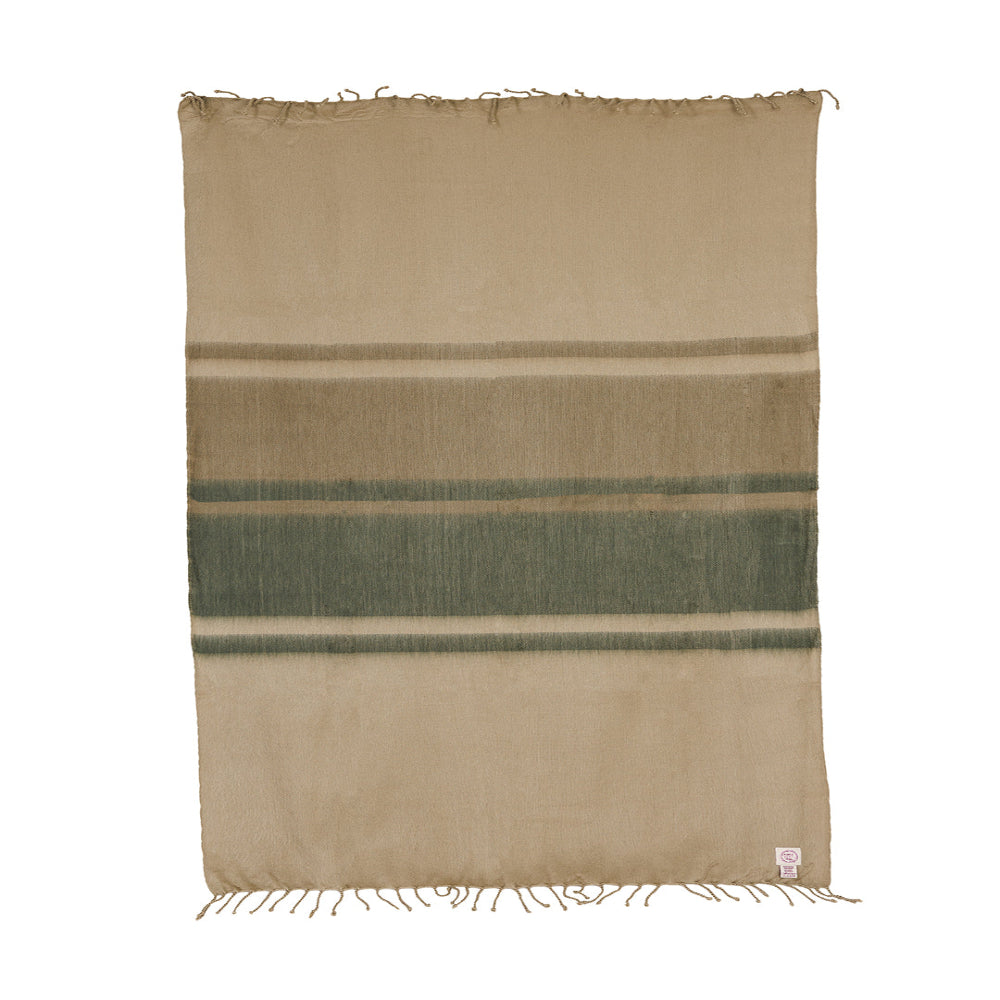 Flat lay of unfolded Ecuadorian alpaca throw showing horizontal stripes and twisted fringe on white background