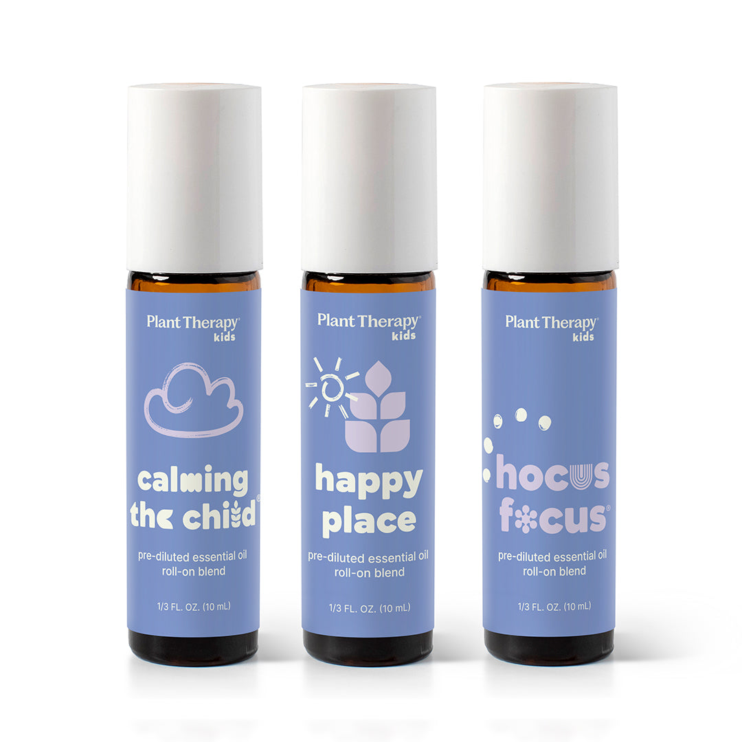 Three amber glass roll-on bottles with periwinkle labels showing cloud, sun, and bubble icons against a white background