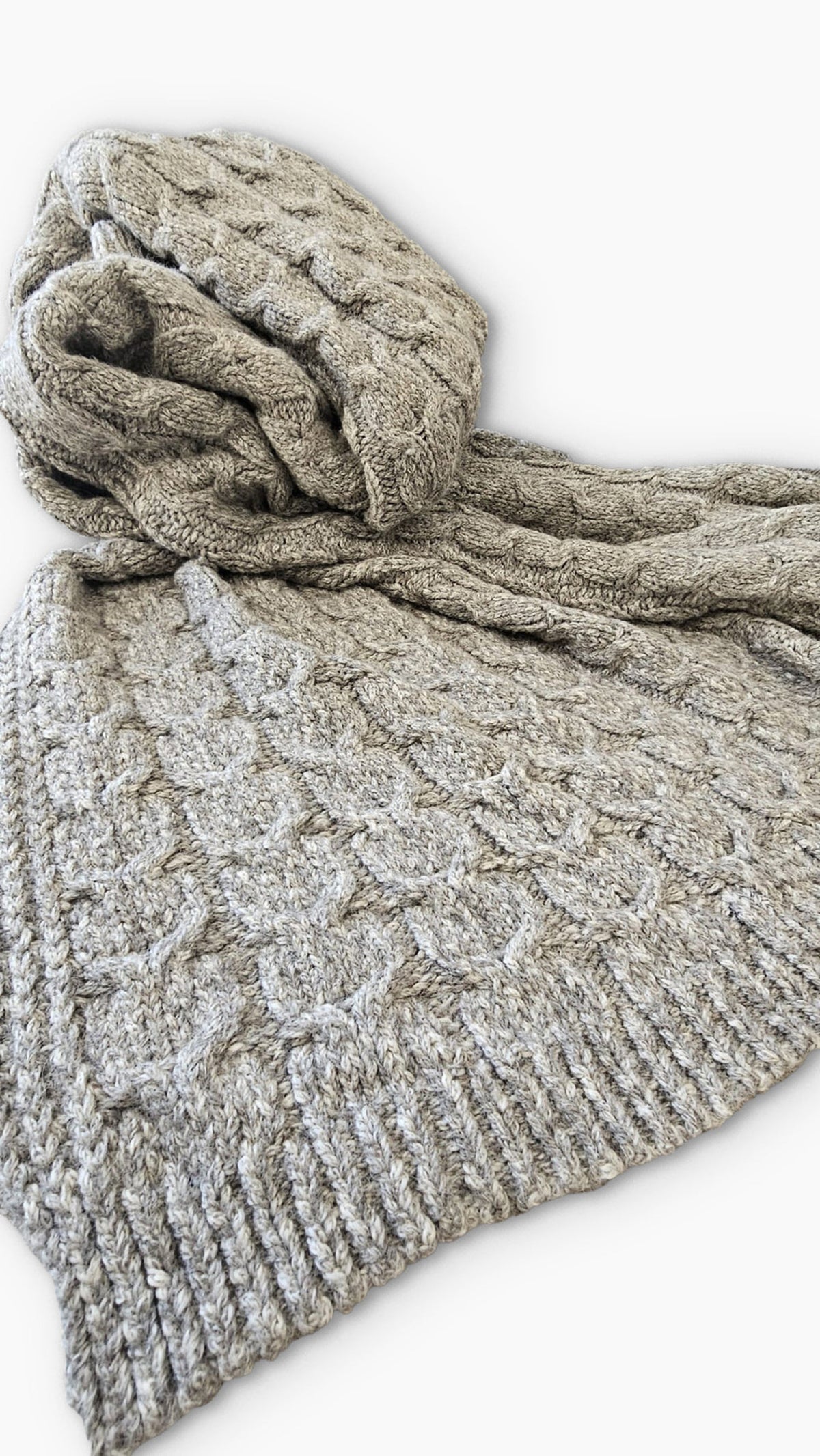 Close up of undyed graphite gray cable weave and ribbed border