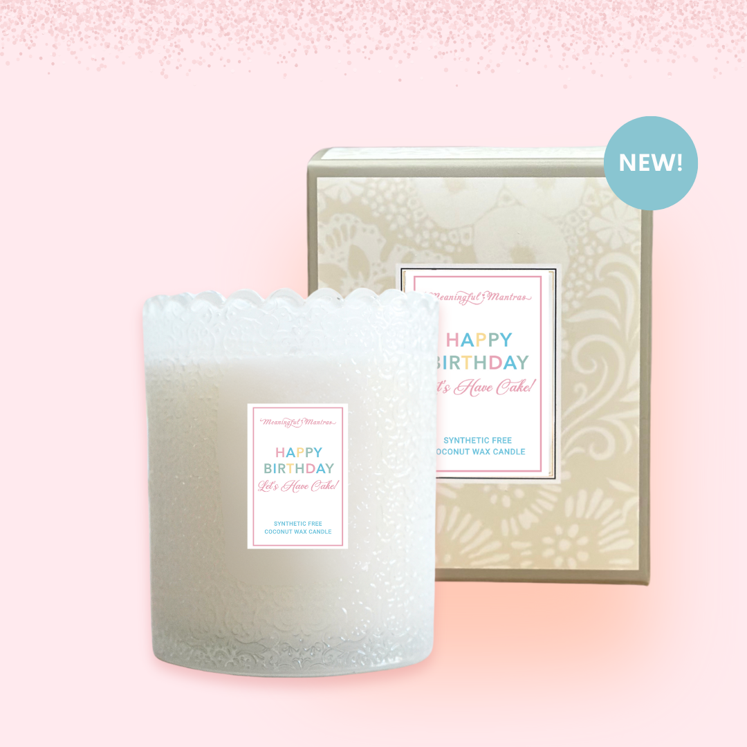 White birthday candle and patterned box displayed against soft pink gradient background with glitter effects
