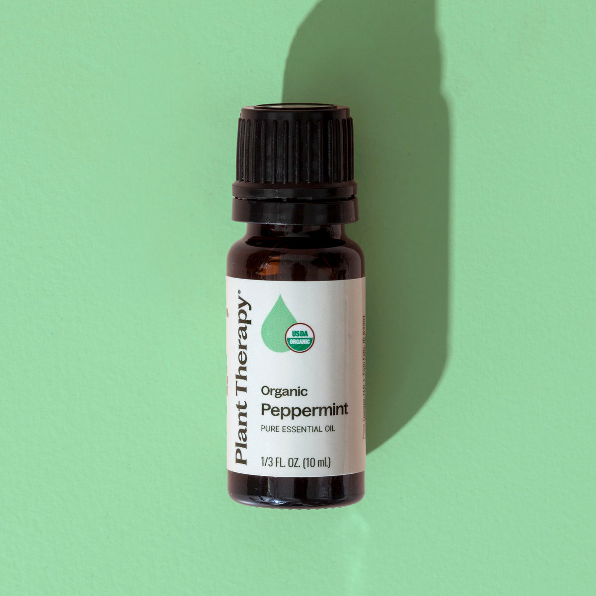 Single 10 mL amber bottle of Plant Therapy organic peppermint oil with black cap