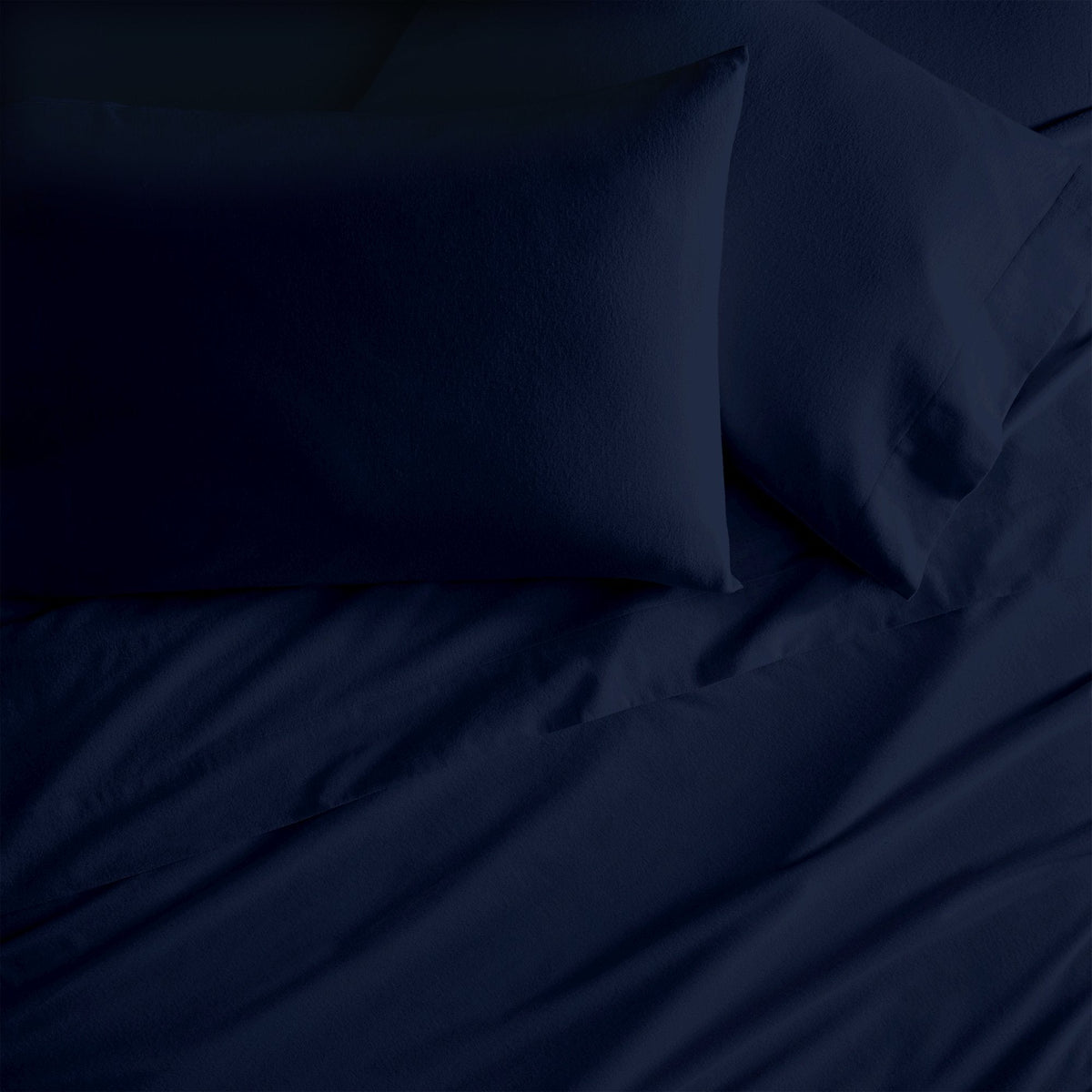 Deep navy blue flannel bedding highlighting rich color depth and soft texture