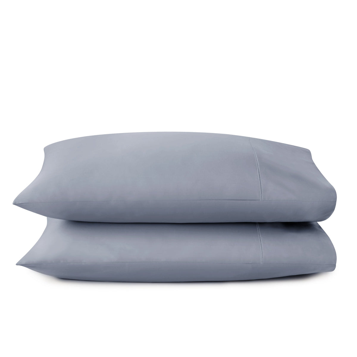 Folded cool slate blue GOTS-certified sateen pillowcases emphasizing silky hand-feel on white background