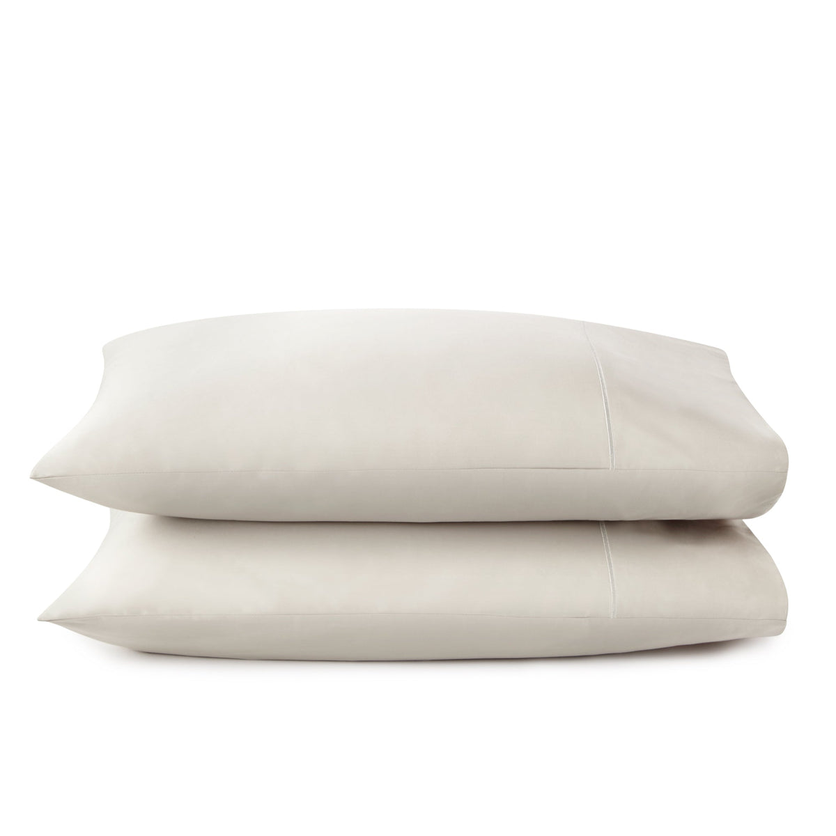 Soft beige oatmeal sateen pillowcases with subtle sheen and visible envelope closure stitching