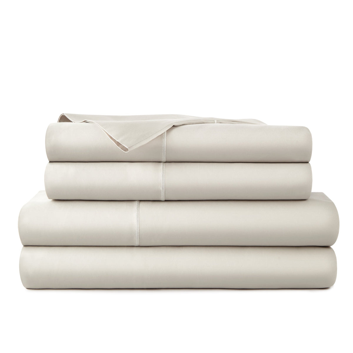 Folded stack of warm beige Whisper Organics 300TC sateen sheet set featuring smooth texture and subtle piping detail